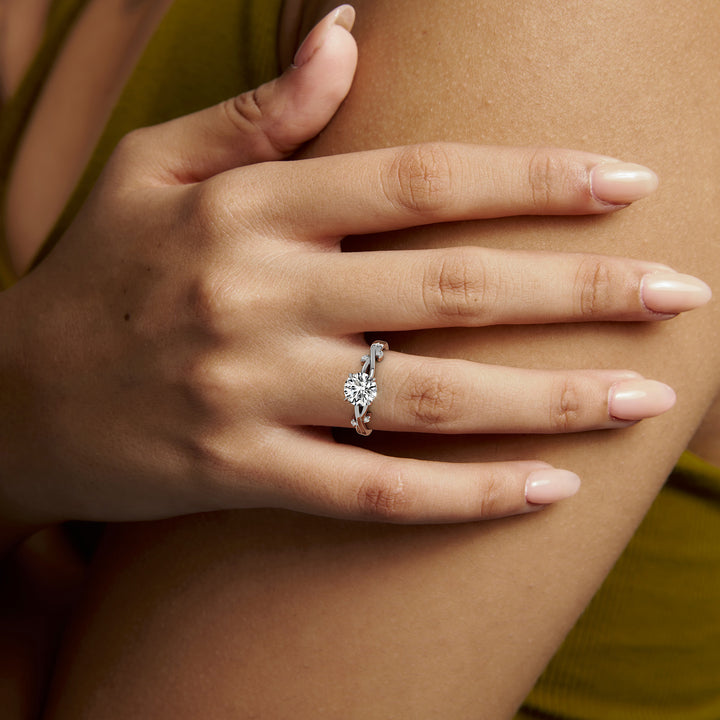 White gold round brilliant-cut nature-inspired branch and leaf engagement ring, worn on the hand