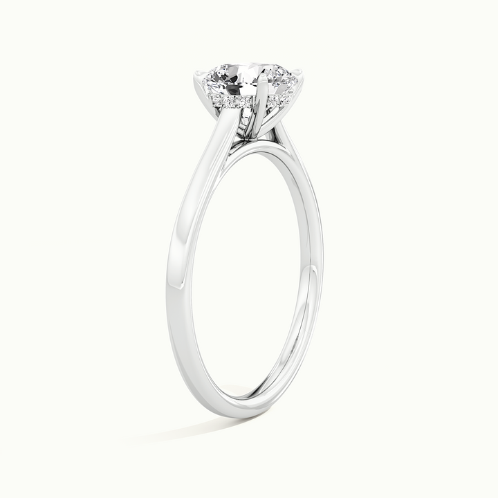 White gold round brilliant-cut cathedral hidden halo engagement ring, raised three-quarter view of the setting