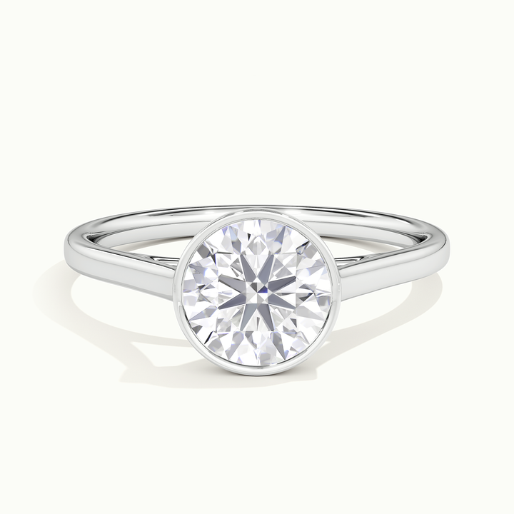 White gold round brilliant-cut bezel-set solitaire engagement ring, front view