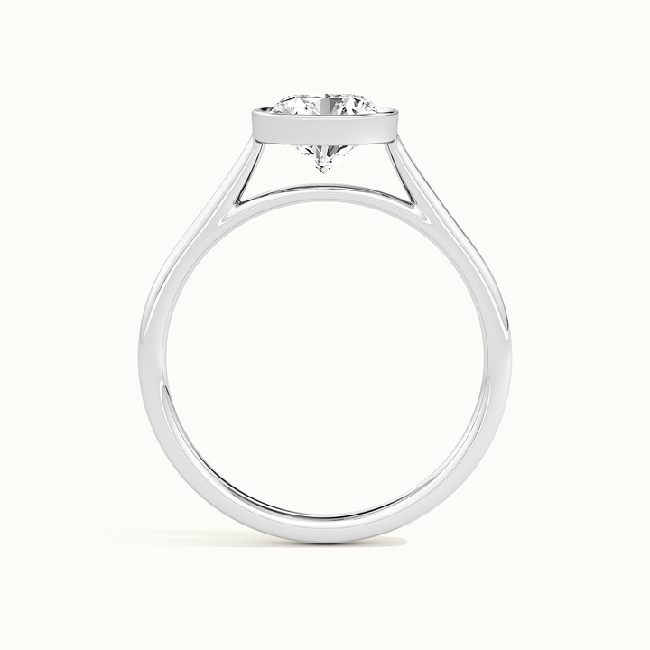 White gold round brilliant-cut bezel-set solitaire engagement ring, side profile showing the bezel setting height