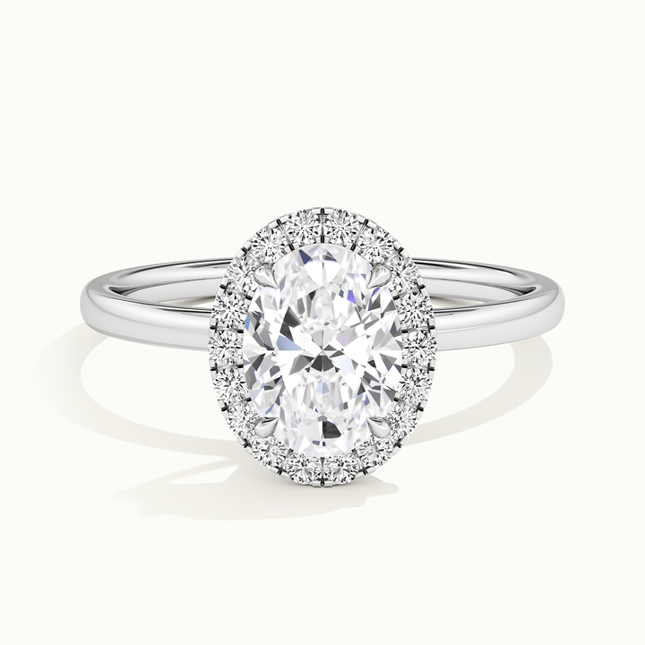 White gold oval-cut halo engagement ring, front view