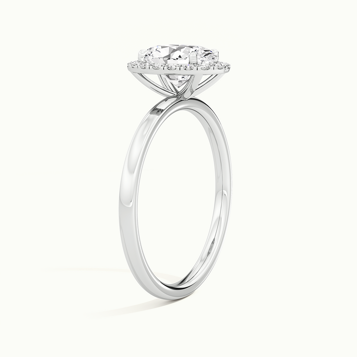 White gold oval-cut halo engagement ring, raised three-quarter view of the setting