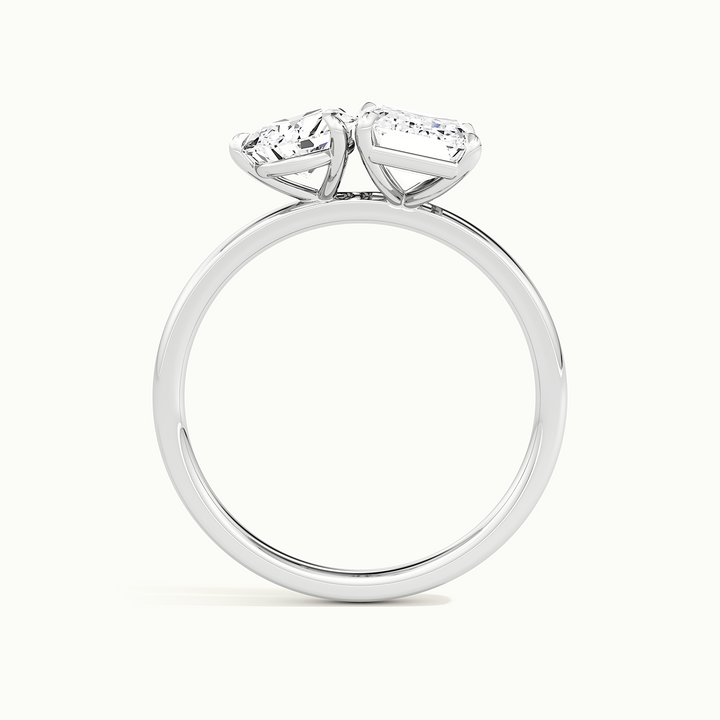 White gold toi et moi pear-and-emerald two-stone engagement ring, raised three-quarter view of the setting