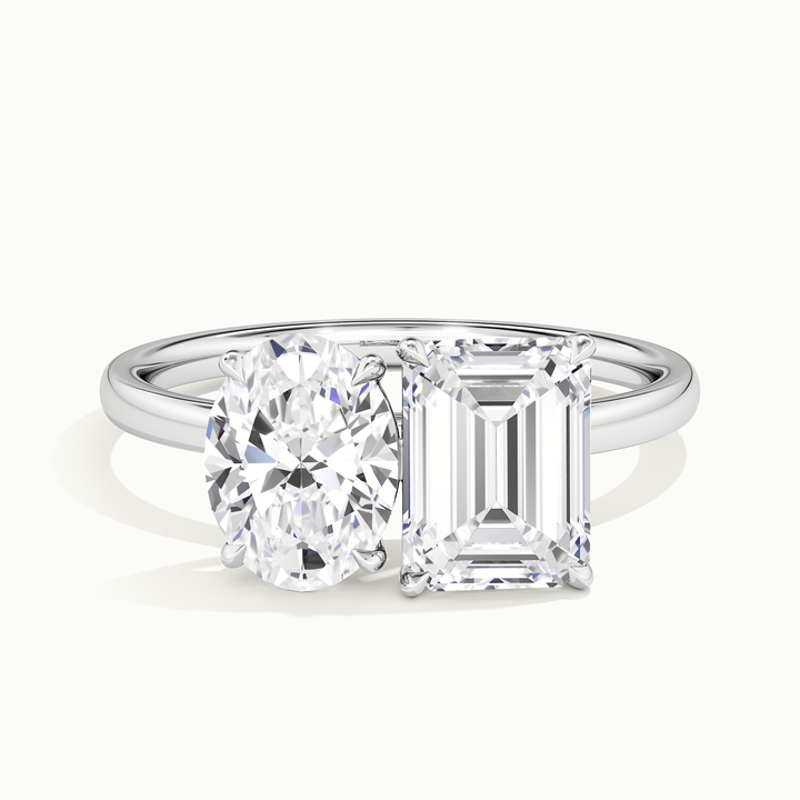 White gold toi et moi oval-and-emerald two-stone engagement ring, front view
