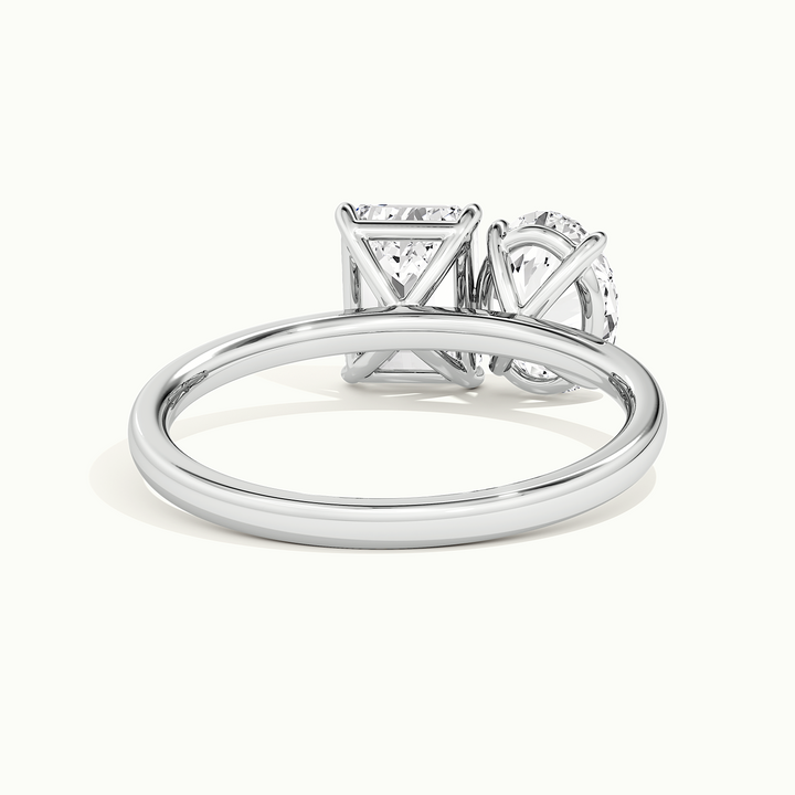 White gold toi et moi oval-and-emerald two-stone engagement ring, side profile showing setting height