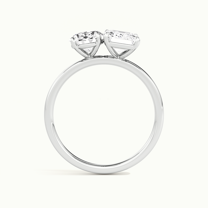 White gold toi et moi oval-and-emerald two-stone engagement ring, raised three-quarter view of the setting