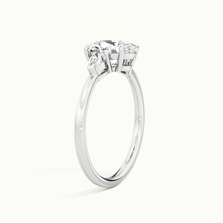 White gold oval-cut three-stone engagement ring, raised three-quarter view of the setting