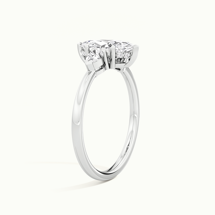 White gold marquise-cut three-stone engagement ring, raised three-quarter view of the setting
