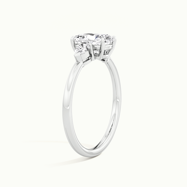White gold elongated cushion-cut three-stone engagement ring, raised three-quarter view of the setting