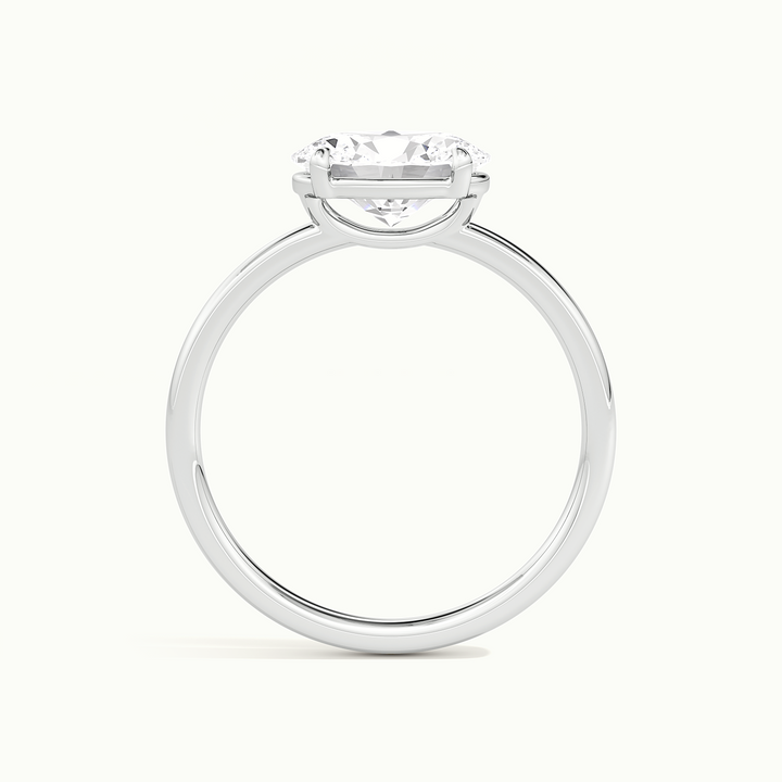 White gold oval-cut east-west solitaire engagement ring, side profile showing setting height