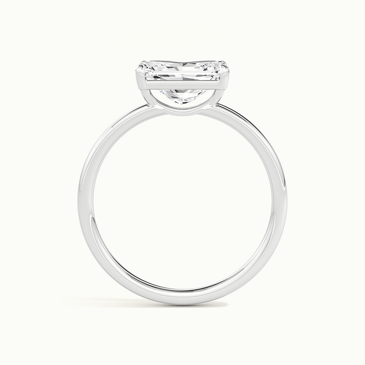 White gold radiant-cut east-west solitaire engagement ring, side profile showing setting height
