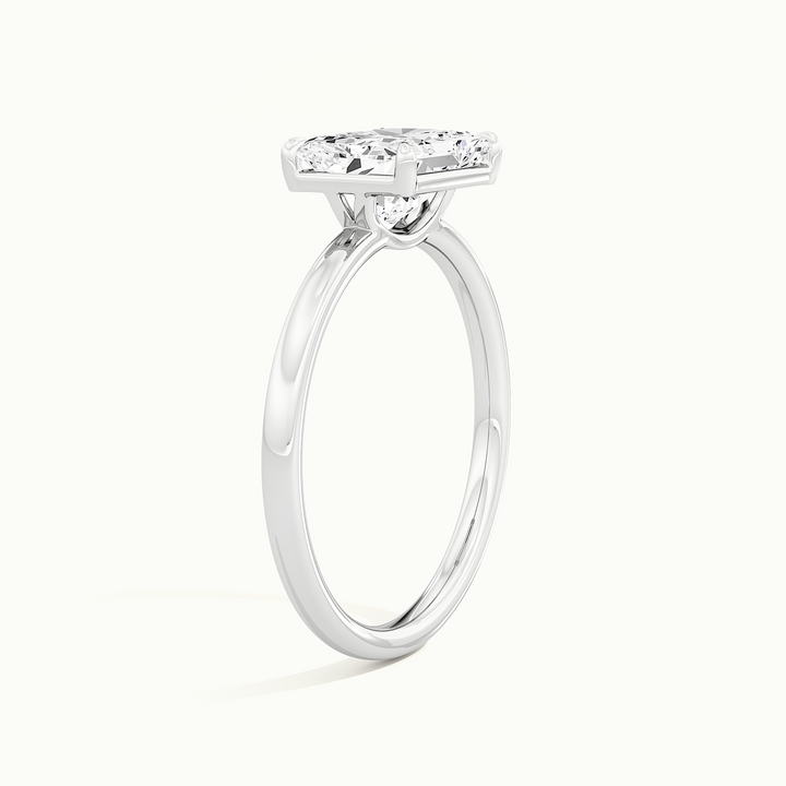 White gold radiant-cut east-west solitaire engagement ring, raised three-quarter view of the setting