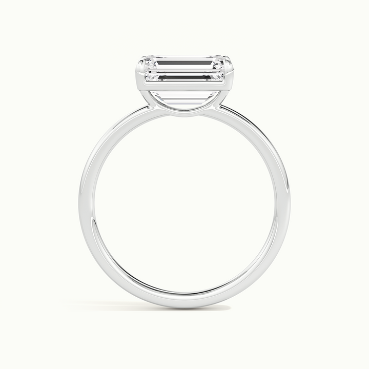 White gold emerald-cut east-west solitaire engagement ring, side profile showing setting height