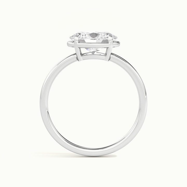 White gold oval-cut east-west bezel-frame solitaire engagement ring, side profile showing setting height
