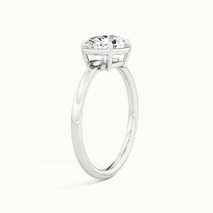 White gold oval-cut east-west bezel-frame solitaire engagement ring, raised three-quarter view of the setting