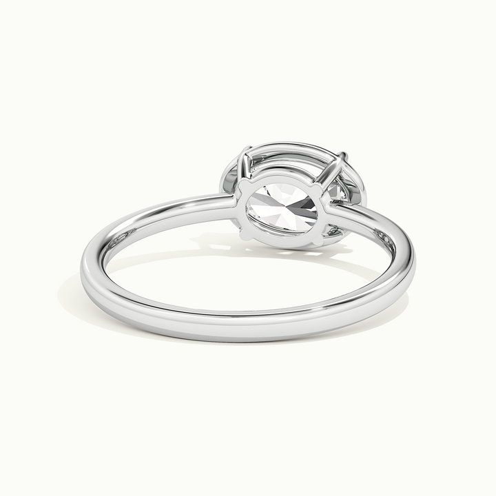 White gold oval-cut east-west bezel-frame solitaire engagement ring, rear view showing the setting gallery