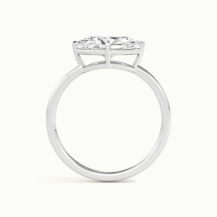 White gold marquise-cut east-west bezel-frame solitaire engagement ring, side profile showing setting height