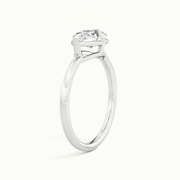 White gold marquise-cut east-west bezel-frame solitaire engagement ring, raised three-quarter view of the setting