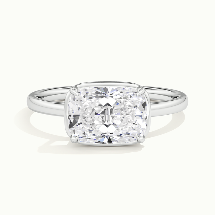 White gold elongated cushion-cut east-west bezel-frame solitaire engagement ring, front view
