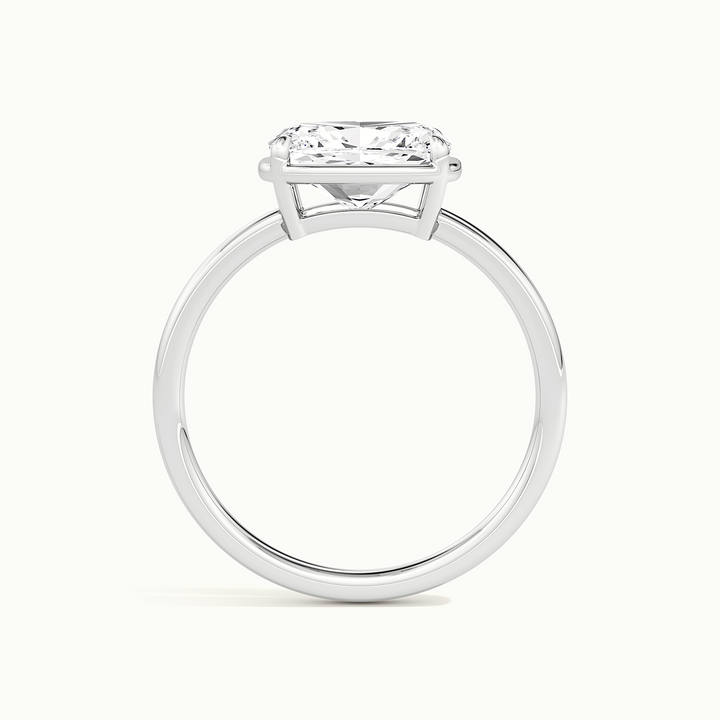 White gold elongated cushion-cut east-west bezel-frame solitaire engagement ring, side profile showing setting height