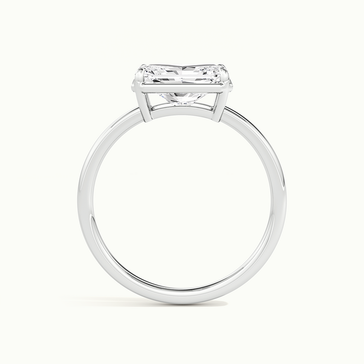 White gold radiant-cut east-west bezel-frame solitaire engagement ring, side profile showing setting height