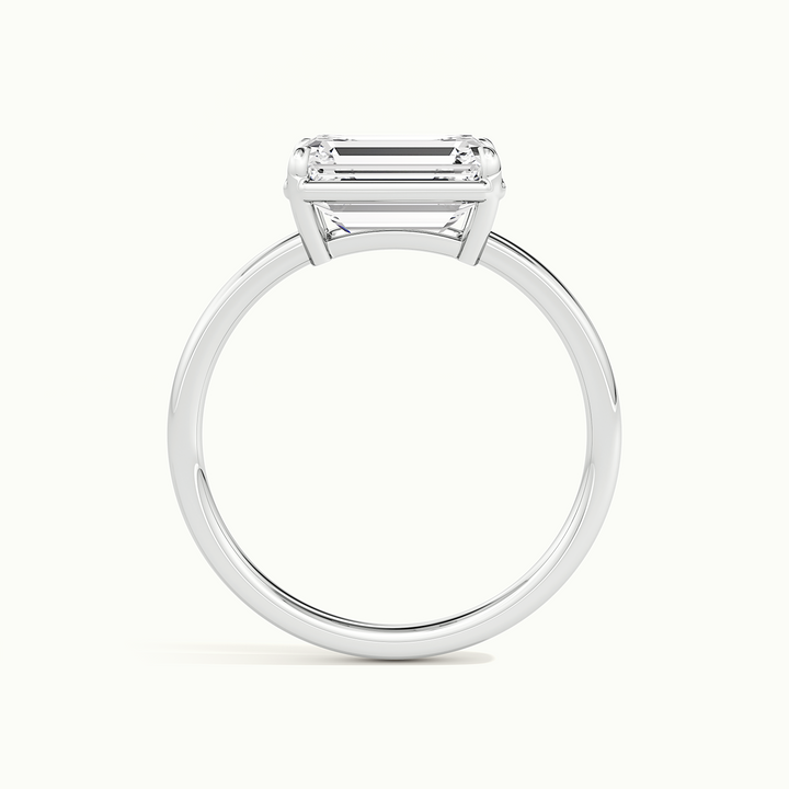 White gold emerald-cut east-west bezel-frame solitaire engagement ring, side profile showing setting height