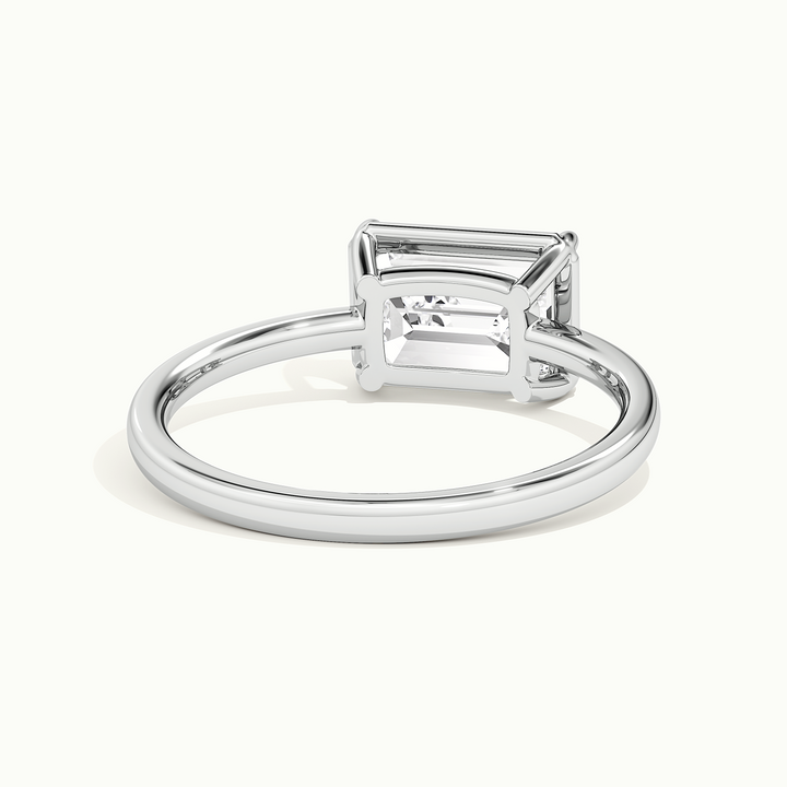 White gold emerald-cut east-west bezel-frame solitaire engagement ring, rear view showing the setting gallery