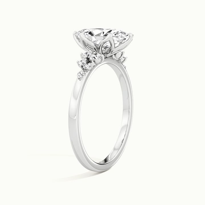 White gold marquise-cut side-stone cluster engagement ring, raised three-quarter view of the setting
