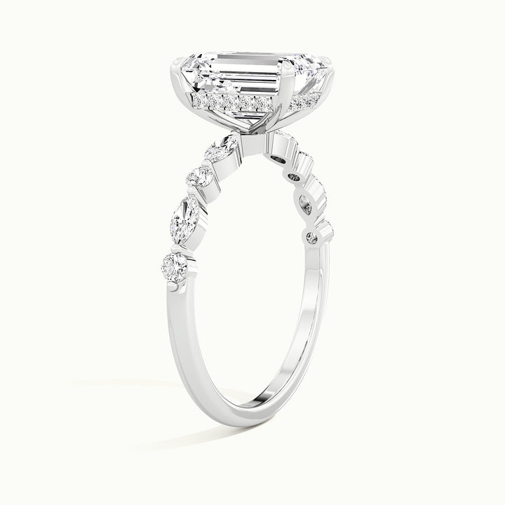 White gold emerald-cut hidden halo with marquise and round side stones, raised three-quarter view of the setting