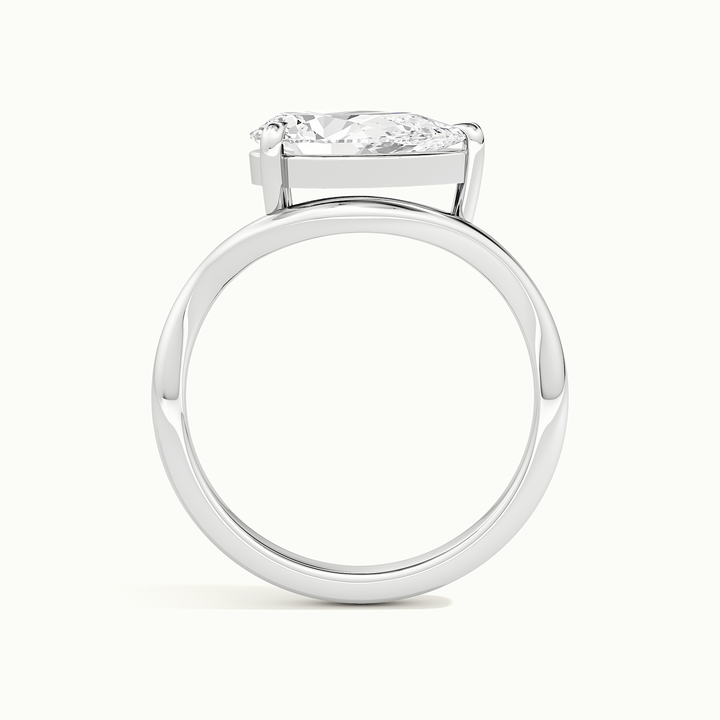 White gold pear-cut east-west solitaire engagement ring, side profile showing setting height