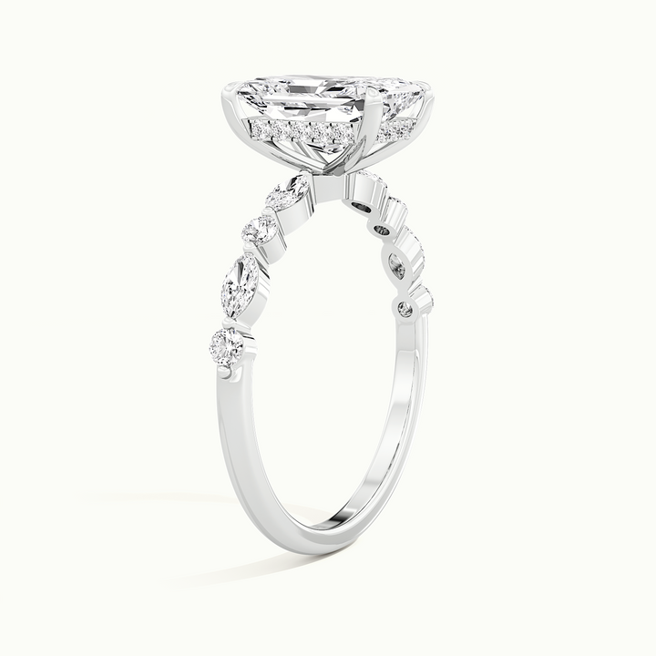 White gold radiant-cut hidden halo with marquise and round side stones, raised three-quarter view of the setting