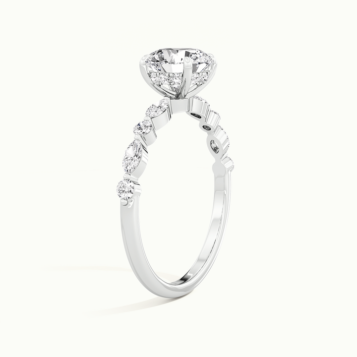 White gold round brilliant-cut hidden halo with marquise and round side stones, raised three-quarter view of the setting