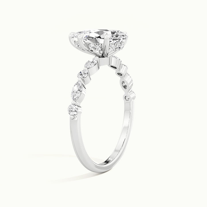 White gold pear-cut hidden halo with marquise and round side stones, raised three-quarter view of the setting