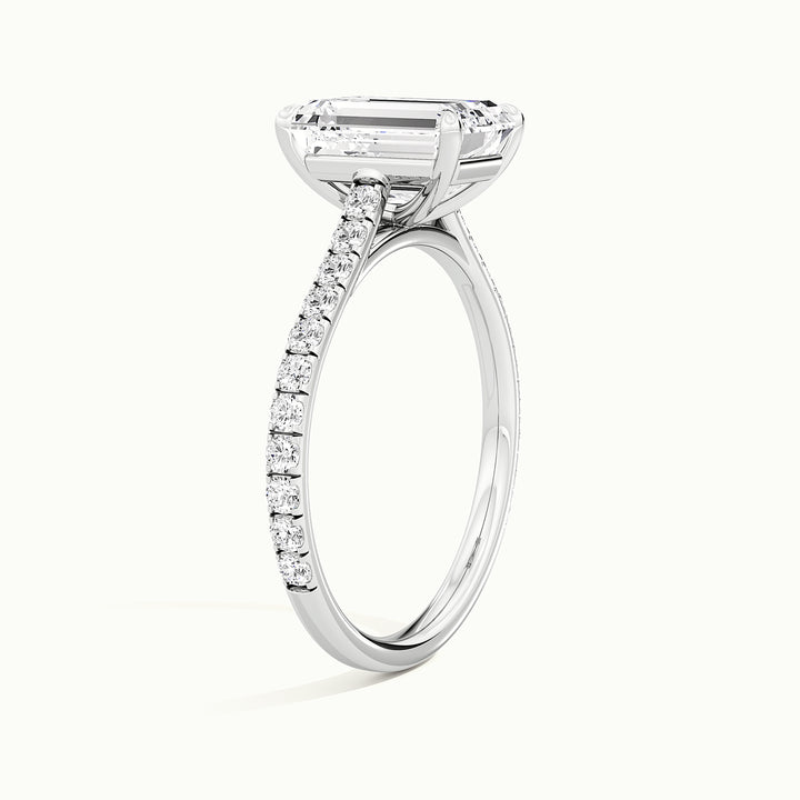 White gold emerald-cut cathedral pave hidden halo engagement ring, raised three-quarter view of the setting