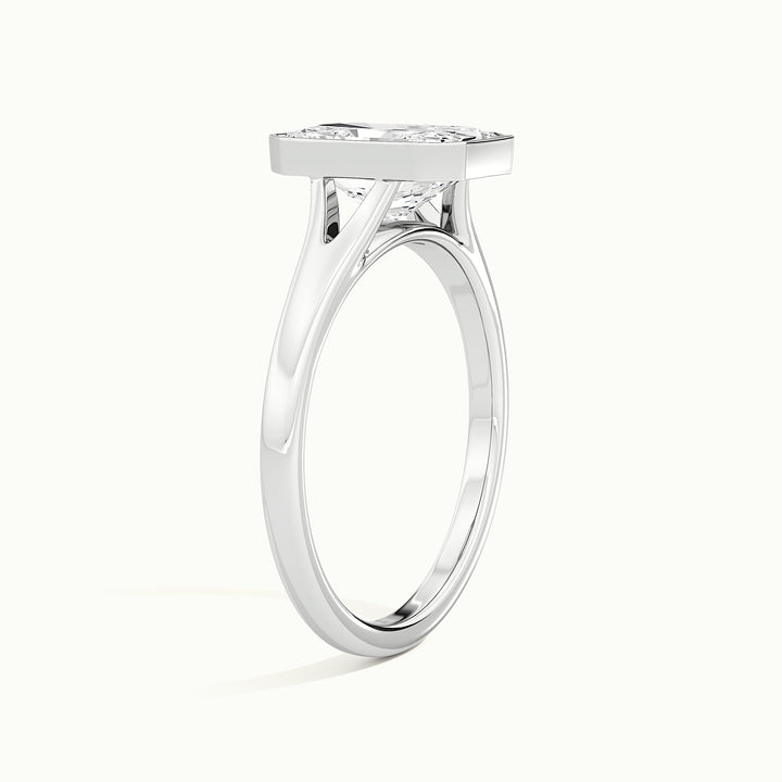 White gold radiant-cut bezel-set split shank solitaire engagement ring, raised three-quarter view of the setting