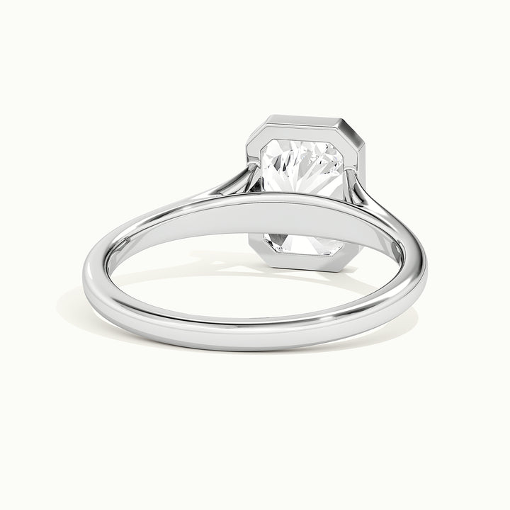 White gold radiant-cut bezel-set split shank solitaire engagement ring, rear view showing the setting gallery