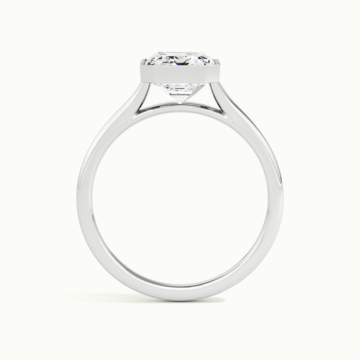 White gold emerald-cut bezel-set split shank solitaire engagement ring, side profile showing setting height