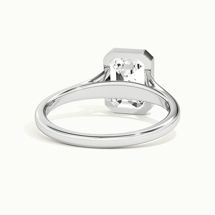 White gold emerald-cut bezel-set split shank solitaire engagement ring, rear view showing the setting gallery