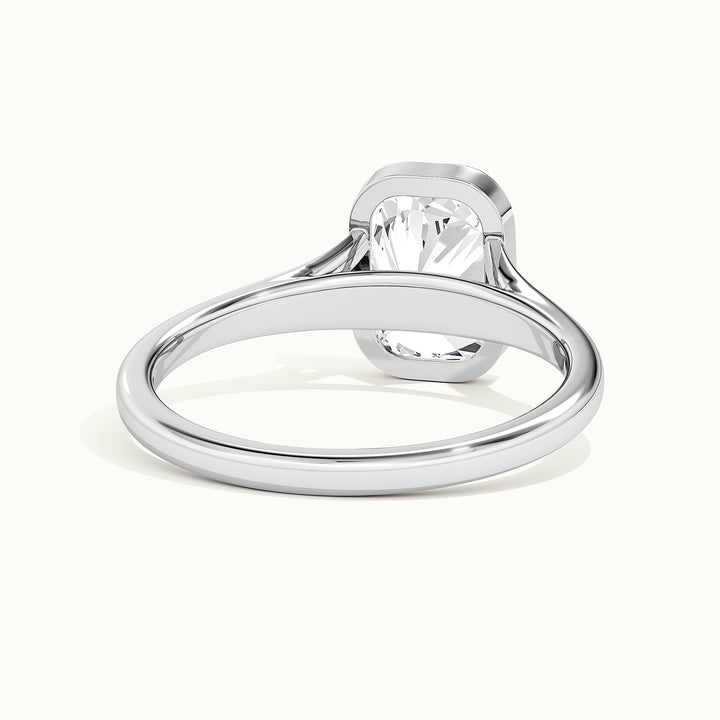 White gold elongated cushion-cut bezel-set split shank solitaire engagement ring, raised three-quarter view of the setting