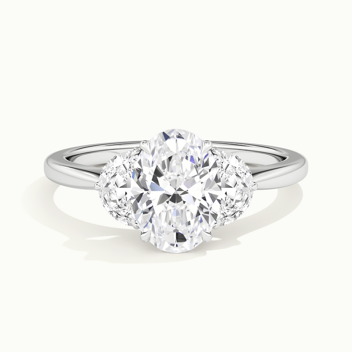 White gold oval-cut three-stone with half-moon side stones, front view
