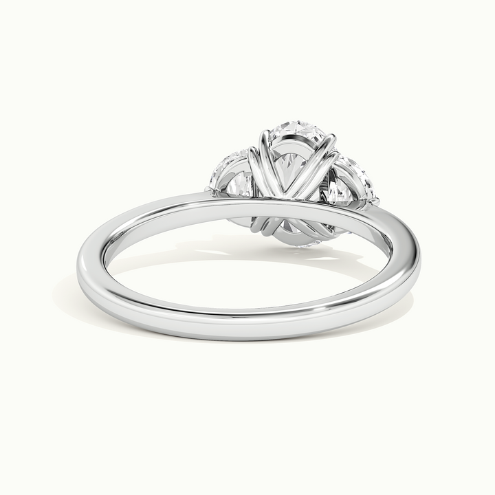 White gold oval-cut three-stone with half-moon side stones, rear view showing the setting gallery