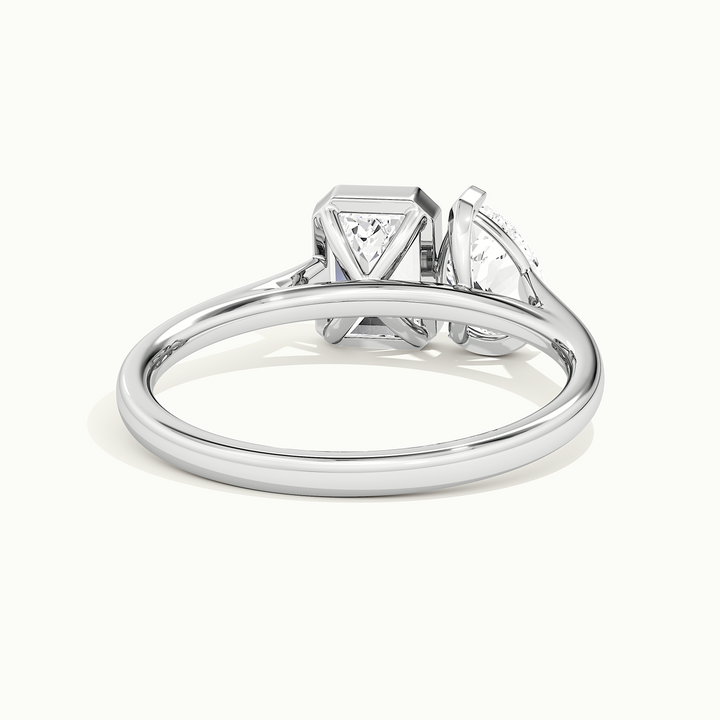 White gold half-bezel toi et moi pear-and-emerald two-stone engagement ring, rear view showing the setting gallery