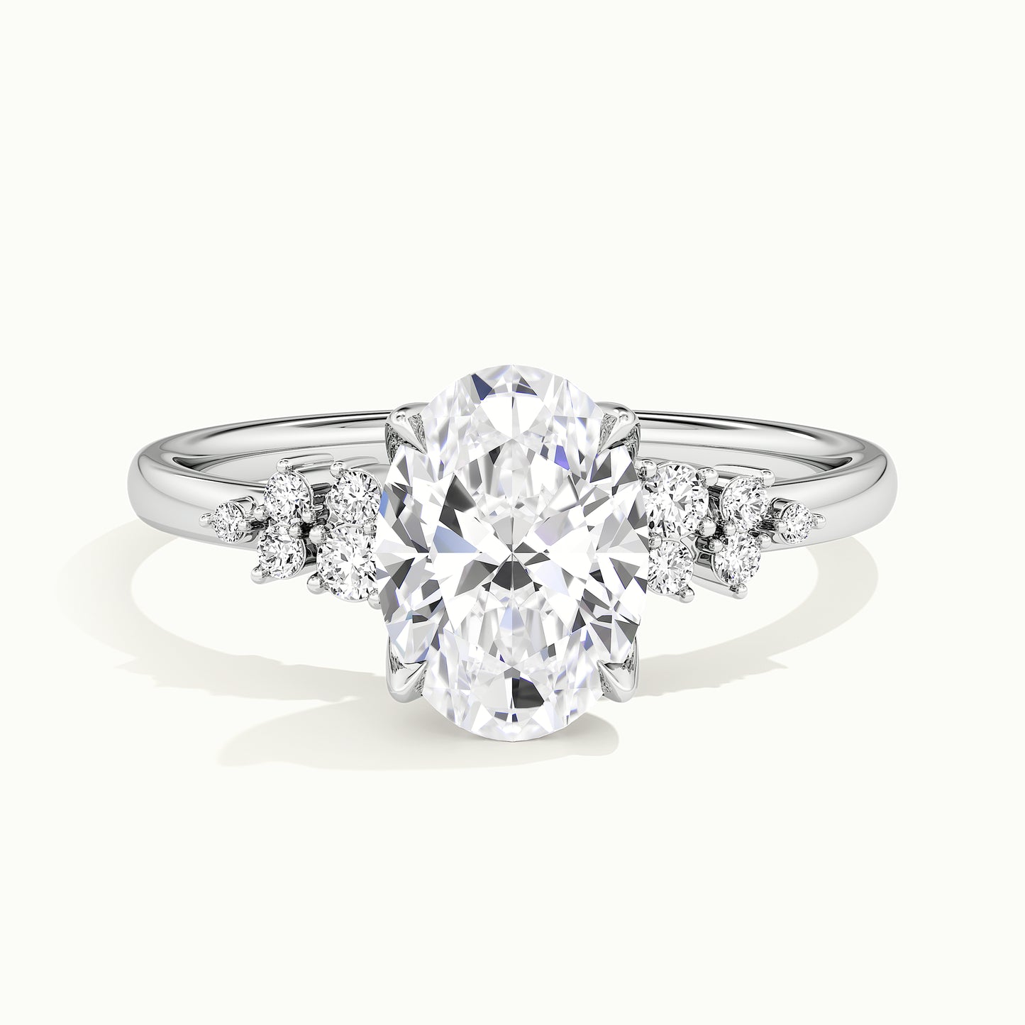 White gold oval-cut clustered shoulder side-stone engagement ring, front view