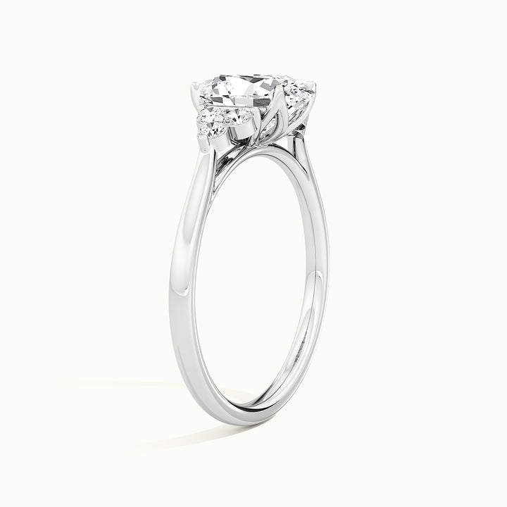 White gold oval-cut vintage-inspired side-stone cluster engagement ring, raised three-quarter view of the setting