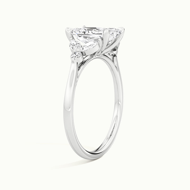 White gold radiant-cut side-stone cluster engagement ring, raised three-quarter view of the setting