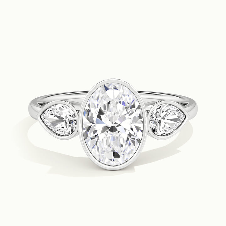 White gold oval-cut bezel-set three-stone with pear side stones engagement ring, front view