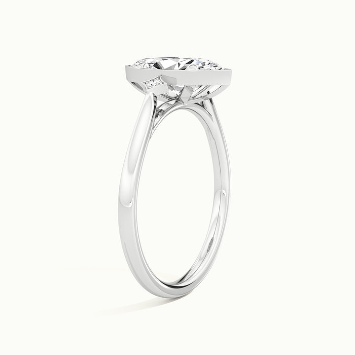White gold marquise-cut bezel-set three-stone engagement ring, raised three-quarter view of the setting