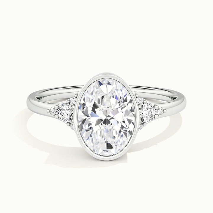 White gold oval-cut bezel-set with side-stone cluster engagement ring, front view