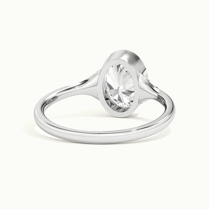 White gold oval-cut bezel-set with side-stone cluster engagement ring, rear view showing the setting gallery