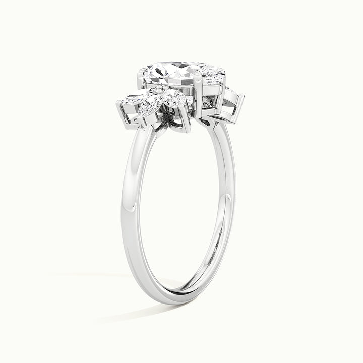White gold oval-cut side-stone cluster engagement ring, raised three-quarter view of the setting